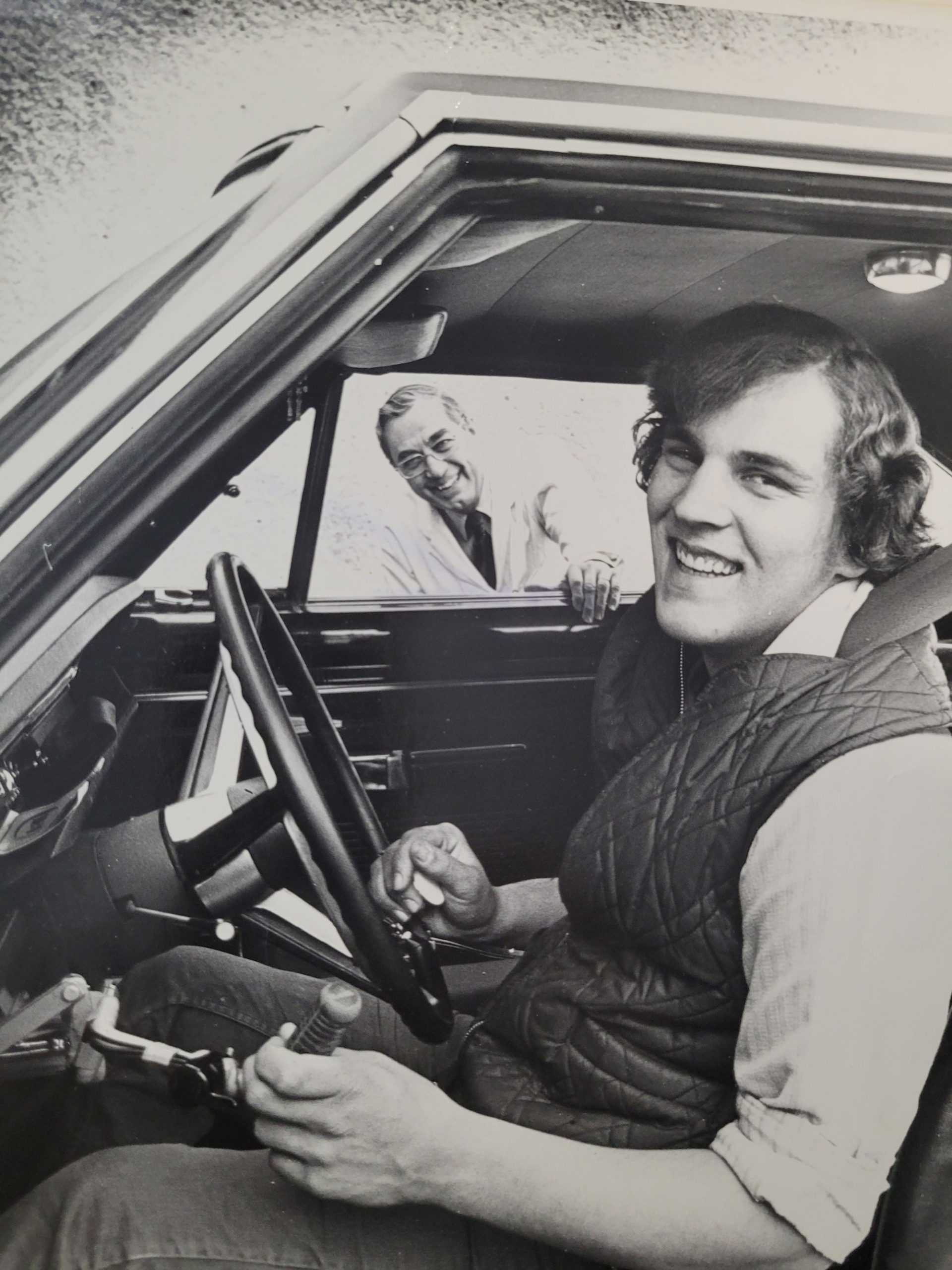 Ken Wright with his doctor pictured in his first adaptive car (note the hand throttle control).